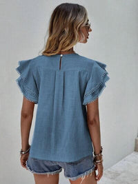 Back view of a woman wearing a Ruffle Cap Sleeve Blouse for Women in blue, showcasing elegant ruffle sleeves.