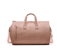 Waterproof leather duffle bag in champagne powder color with adjustable strap for stylish travel.