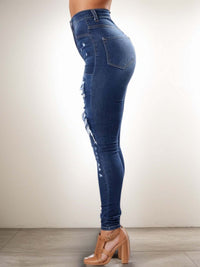 Ripped high waist jeans for women in stylish distressed denim, showcasing a flattering silhouette.
