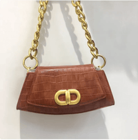 Chic Élan underarm bag in brown with gold chain, showcasing modern French design and elegant functionality.