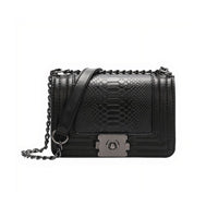 Stylish Bertha shoulder bag made of python-textured vegan leather with chain detail and unique gunmetal closure.
