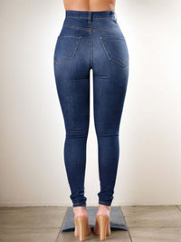 Ripped high waist jeans for women showcasing back view, trendy distressed denim pants with flattering fit.