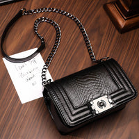 Bertha Shoulder Bag, a vegan leather shoulder bag with python texture and chain detail, stylish and versatile for any occasion.