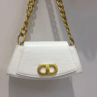 Chic Élan underarm bag in white with a gold chain handle and elegant design, perfect for modern fashion.