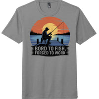 Fishing themed tri-blend tee in grey frost with art of a fisherman at sunset, slogan 'Bord to Fish, Forced to Work'.