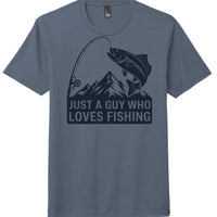Fishing themed tri-blend t-shirt in Navy Frost featuring graphic: 'Just a guy who loves fishing' with mountains and fish.