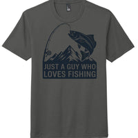 Fishing themed tri-blend t-shirt in charcoal with 'Just a guy who loves fishing' graphic and mountain design.