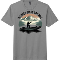 Hooked day one graphic on grey frost perfect tri blend tee featuring fisherman silhouette and mountain background.